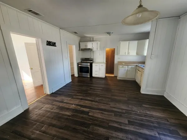 a kitchen with white cabinets and stainless steel appliances