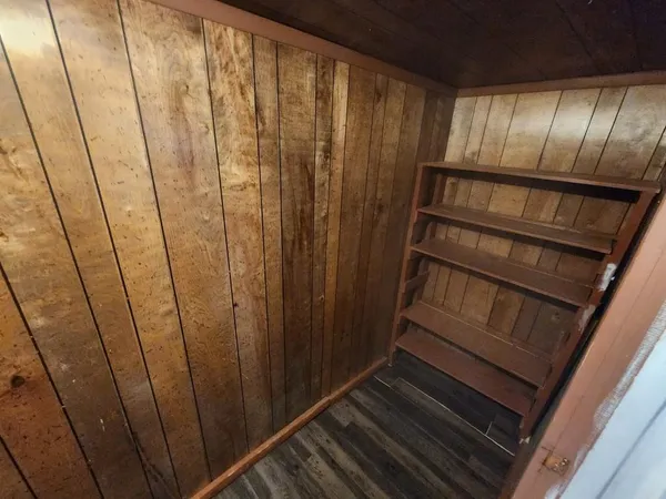 a view of a room with wooden floor and shoes