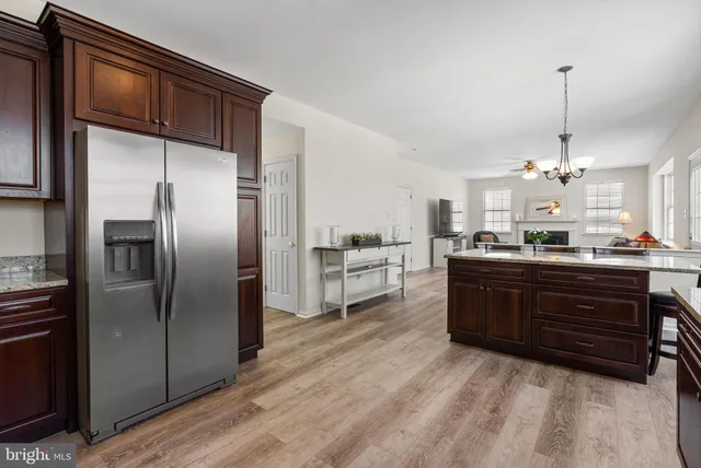 a kitchen with granite countertop a stove and a wooden floors