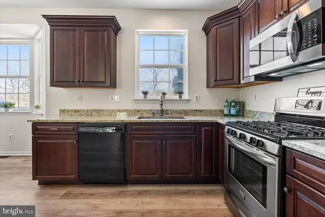 a living room with furniture a fireplace and a large window
