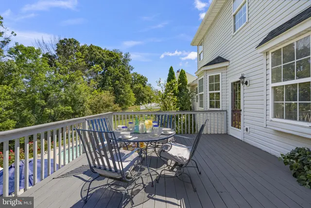 a view of a deck with chairs and wooden floor