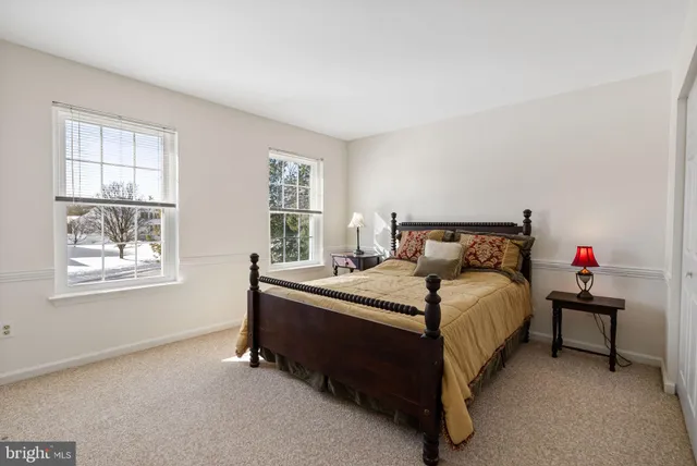 a bathroom with a sink a toilet and a large mirror