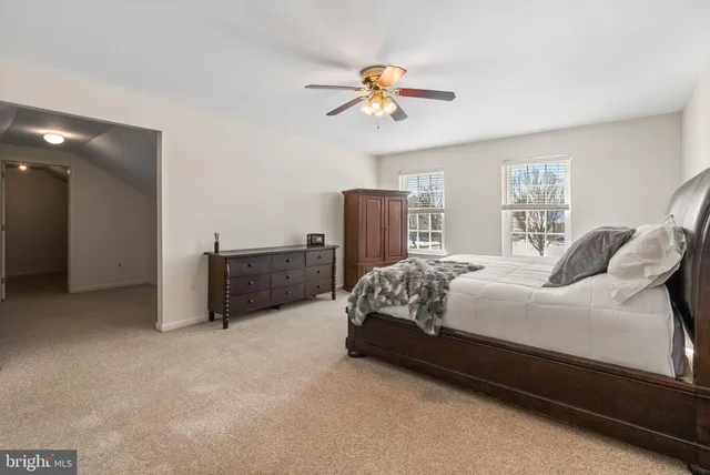 a bedroom with a bed and ceiling fan