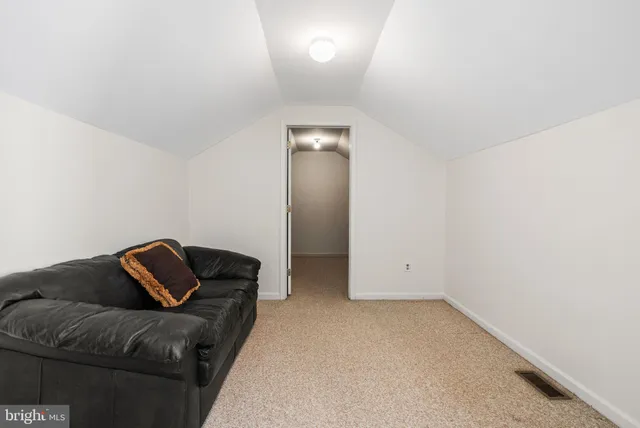 a living room with furniture and a book shelf