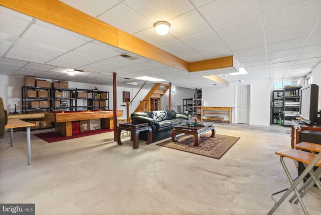 a view of a patio with a table and chairs under an umbrella