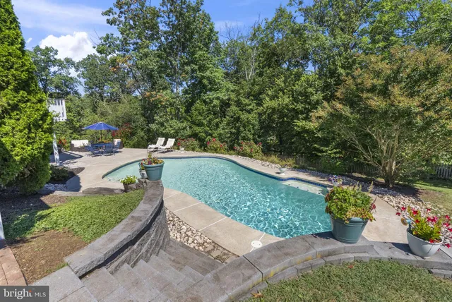 an aerial view of a house with a yard and lake view