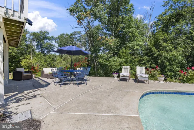 an aerial view of a house with outdoor space and a lake view