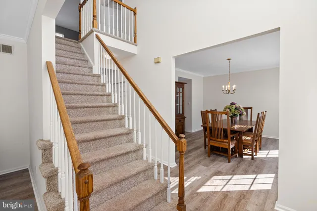a view of entryway with wooden floor and stairs