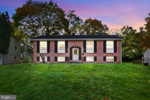 a view of a house with garden and trees