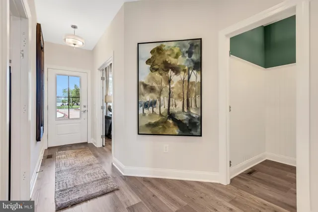 a kitchen with stainless steel appliances a stove a sink a oven a dining table and chairs