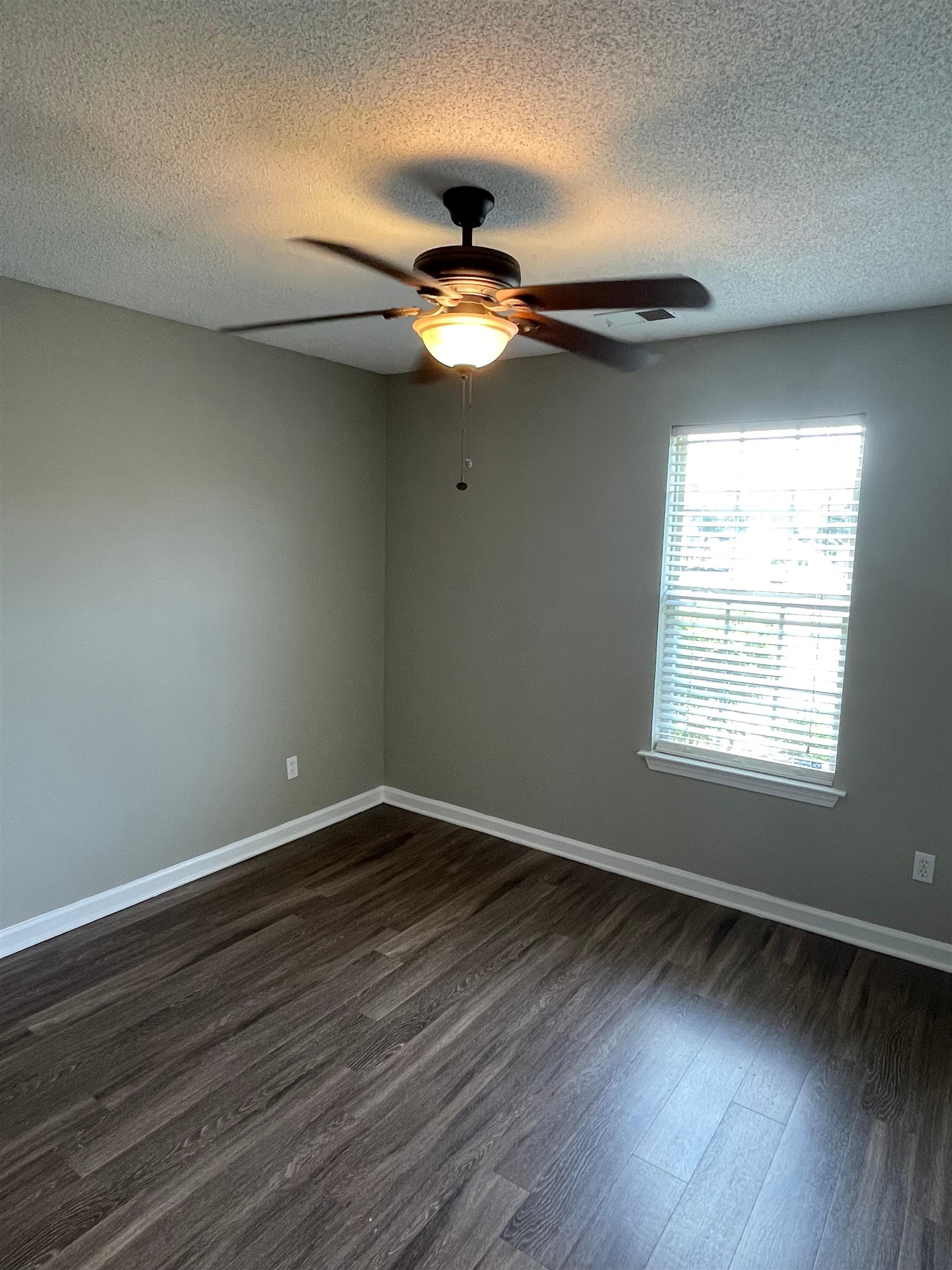 4580 Sun Ridge Drive Memphis, TN 38128 - Photo 13 of 16 Unfurnished room with dark wood-type flooring, a ceiling fan, and a textured ceiling
