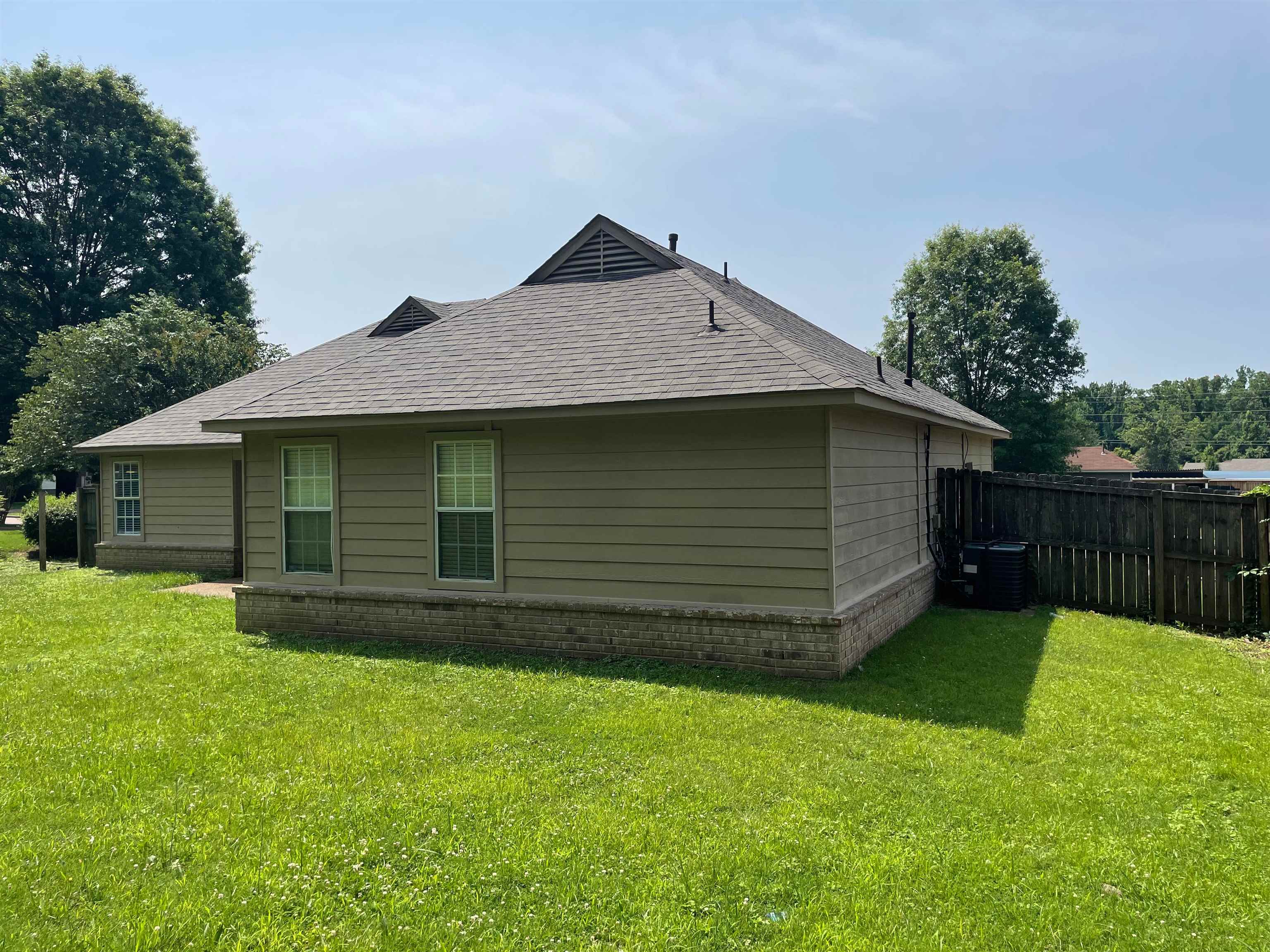4580 Sun Ridge Drive Memphis, TN 38128 - Photo 15 of 16 View of property exterior with a shingled roof and a central AC unit