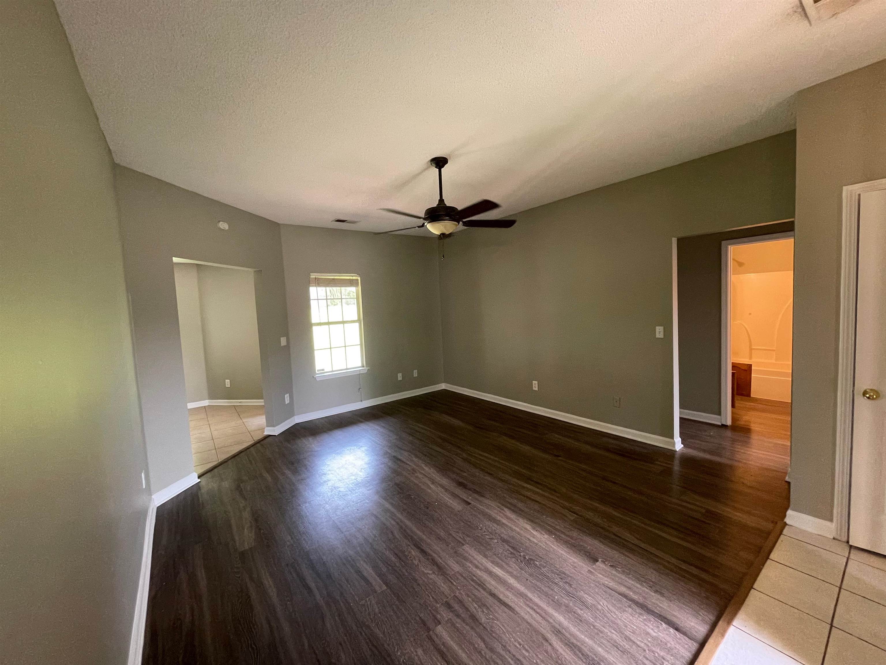 4580 Sun Ridge Drive Memphis, TN 38128 - Photo 2 of 16 Spare room featuring ceiling fan, wood finished floors, and a textured ceiling