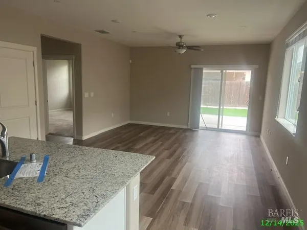 an empty room with wooden floor and cabinet