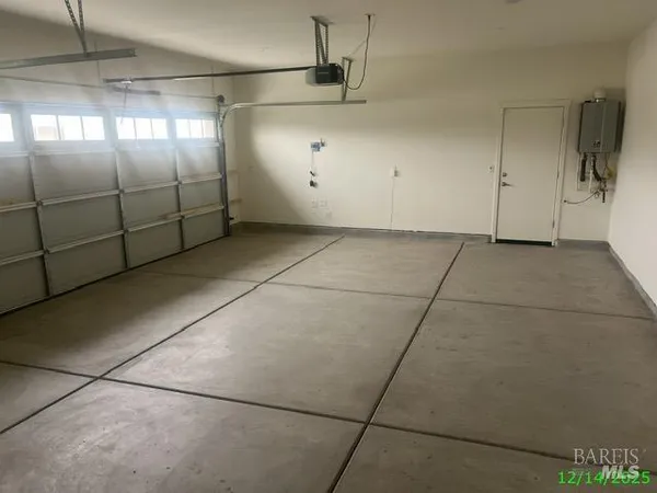 a view of a small space with wooden floor and a window