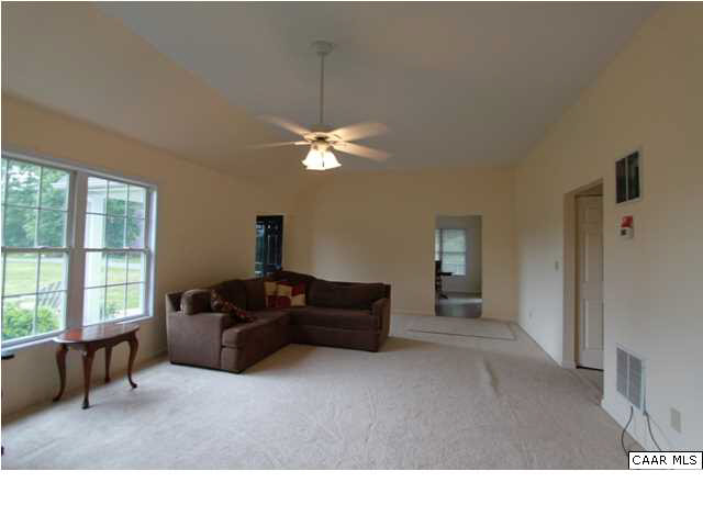 210 Moore Road Ruckersville, VA 22968 - Photo 4 of 18 a living room with furniture windows and a chandelier
