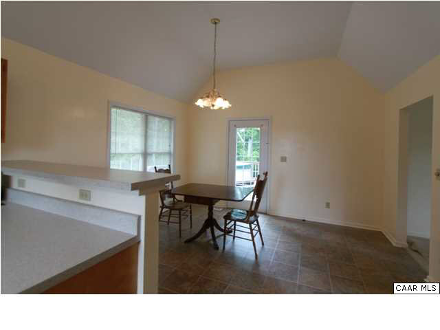 210 Moore Road Ruckersville, VA 22968 - Photo 8 of 18 a living room with furniture and a chandelier