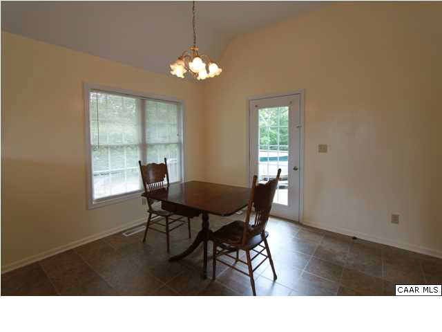 210 Moore Road Ruckersville, VA 22968 - Photo 9 of 18 a dining room with wooden floor and a chandelier