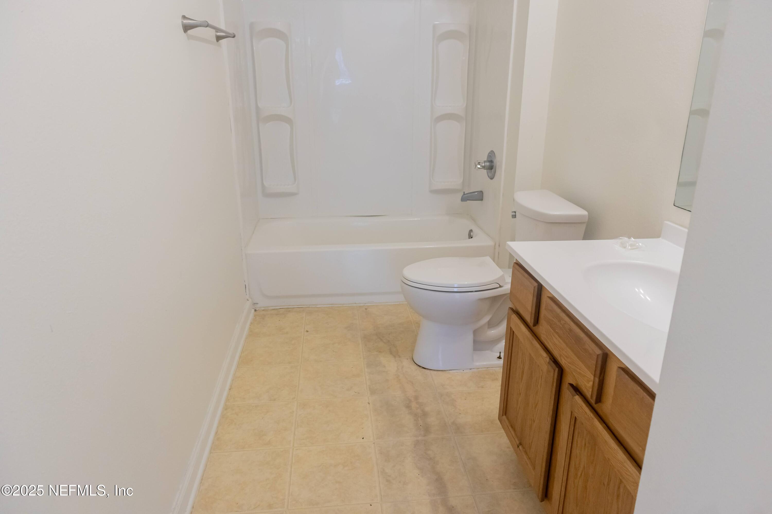 3680 Kirkpatrick Circle, Unit 5 Jacksonville, FL 32210 - Photo 4 of 10 a bathroom with a sink a toilet and shower