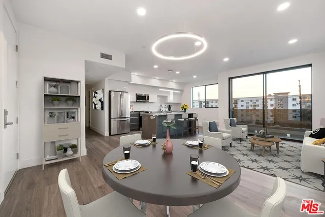 a large kitchen with a table and chairs