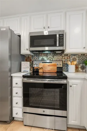 a kitchen with stainless steel appliances granite countertop a stove microwave and refrigerator