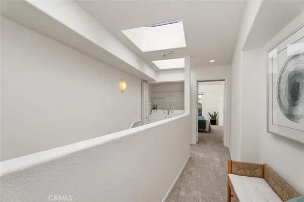 a view of a hallway with a washer and dryer