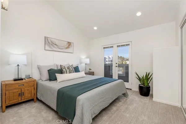a bedroom with a bed and a potted plant