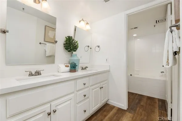 a bathroom with a double vanity sink and mirror