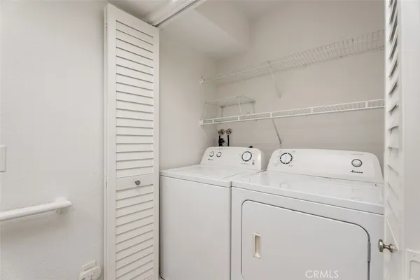 a view of storage and utility room with washer and dryer