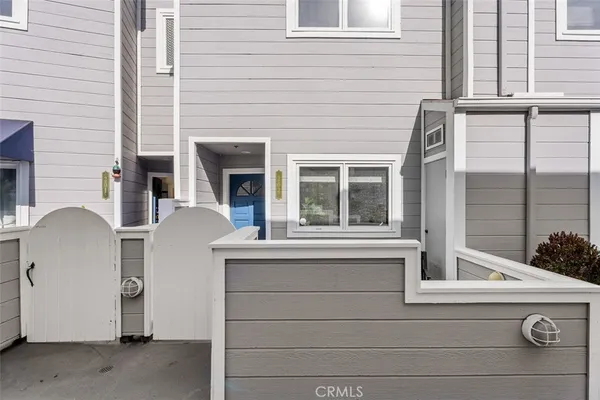 a view of a patio with chairs and a potted plant