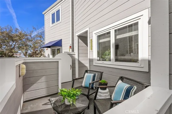 a view of backyard with seating space and potted plants