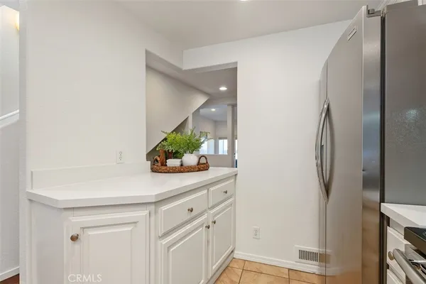 a sink with a mirror and cabinets