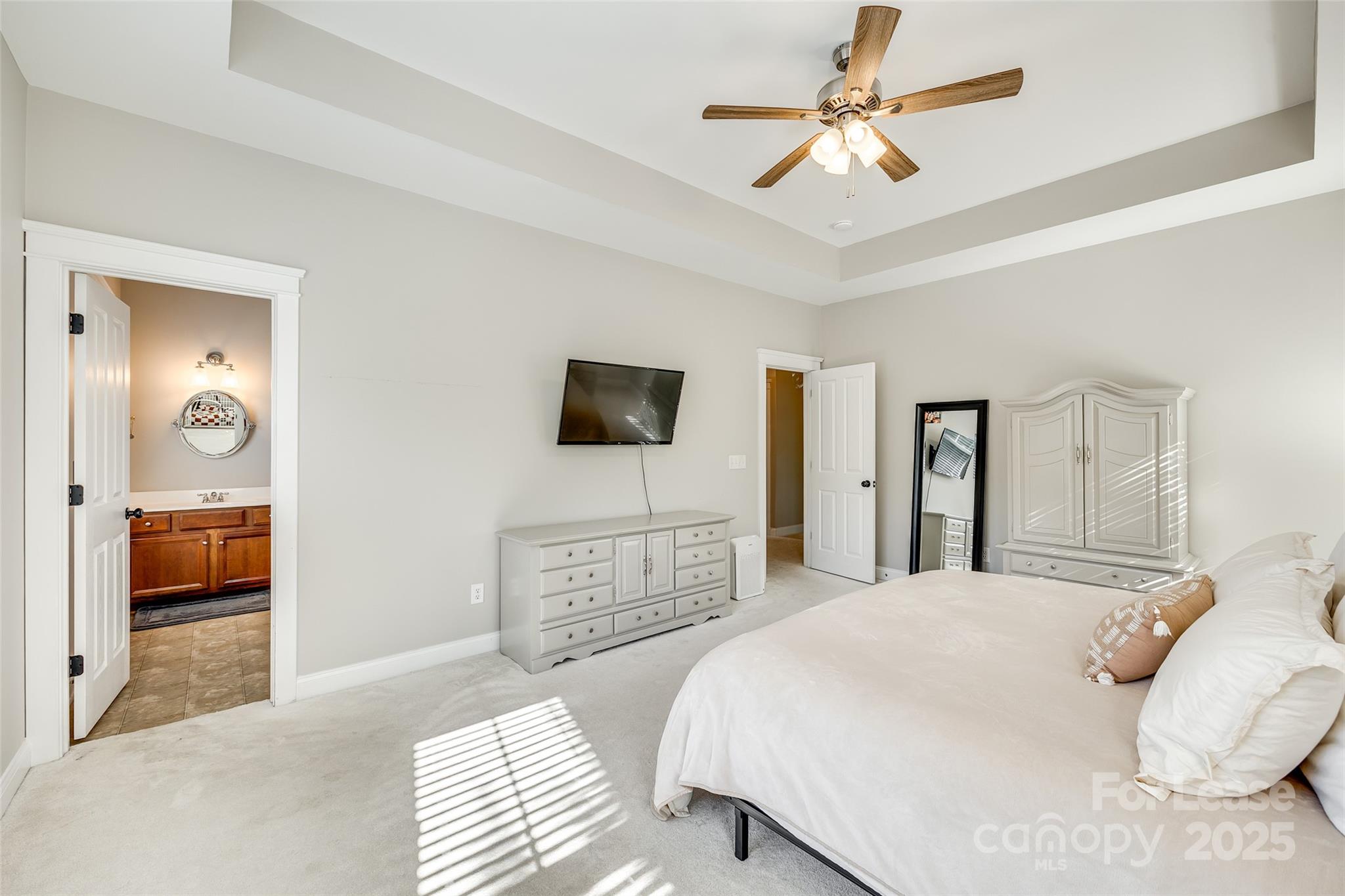 1128 Windsong Bay Lane Fort Mill, SC 29708 - Photo 18 of 35 a bedroom with a bed and a flat screen tv