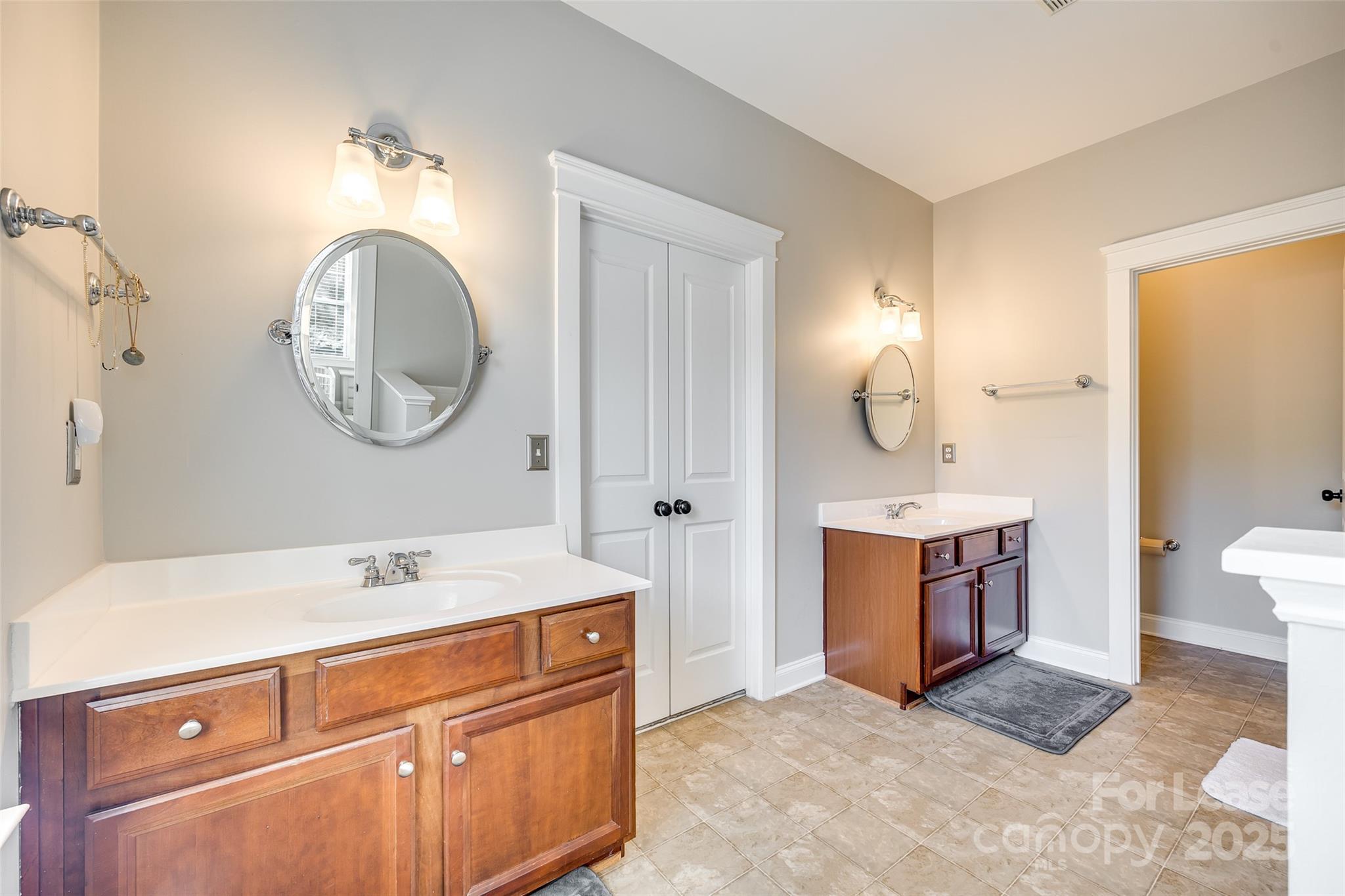1128 Windsong Bay Lane Fort Mill, SC 29708 - Photo 19 of 35 a spacious bathroom with a sink double vanity and a mirror