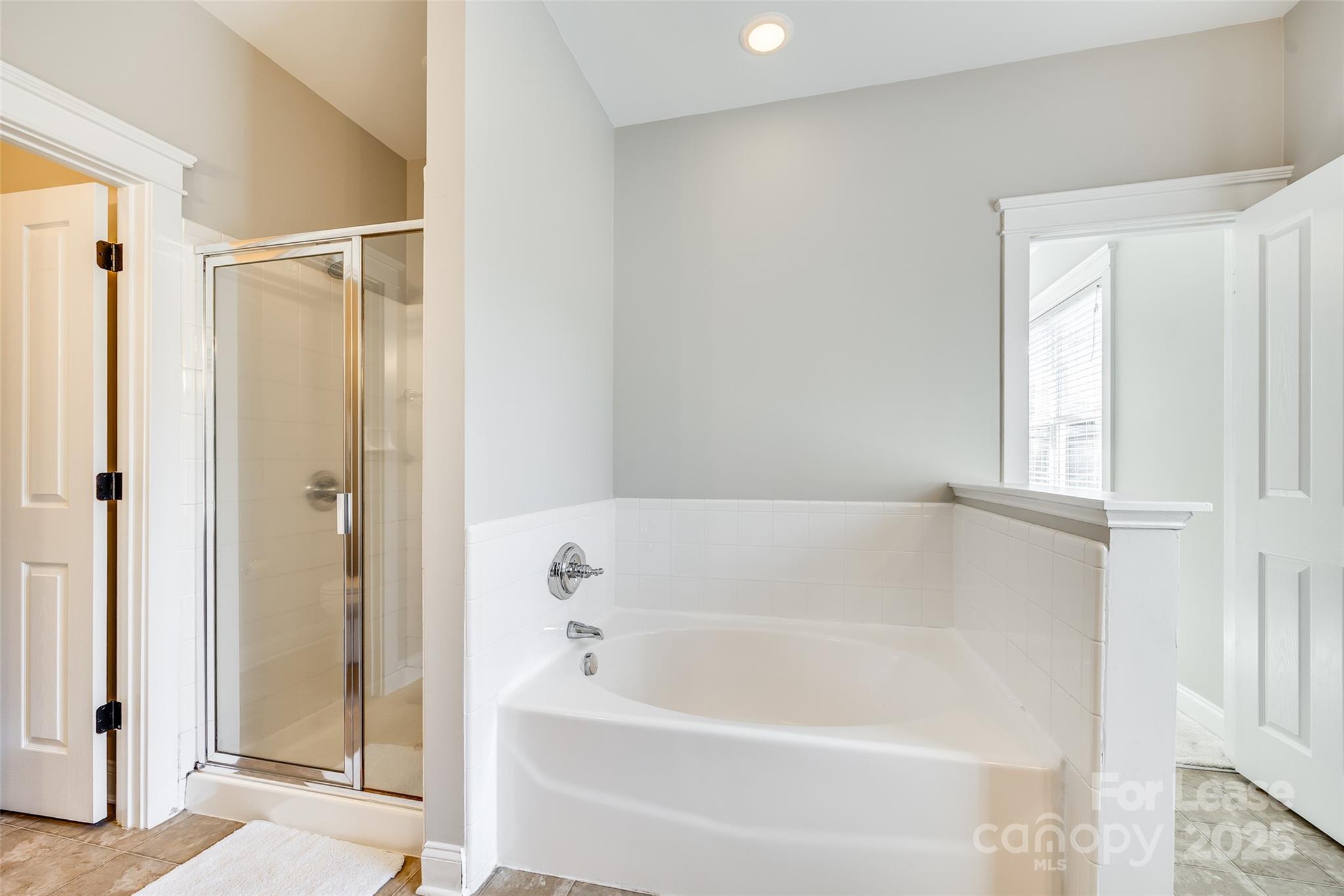 1128 Windsong Bay Lane Fort Mill, SC 29708 - Photo 20 of 35 a white bath tub sitting next to a shower