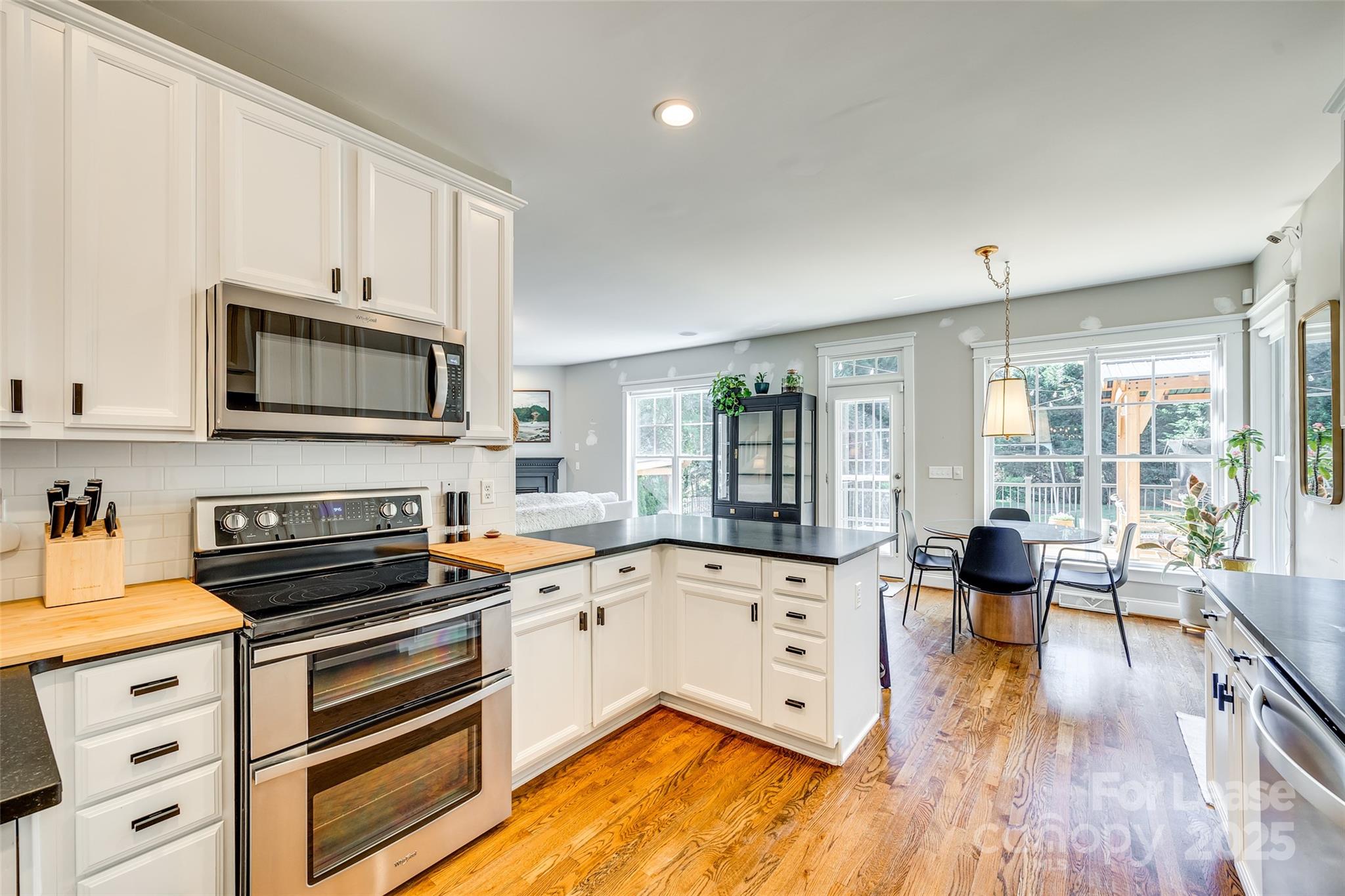 1128 Windsong Bay Lane Fort Mill, SC 29708 - Photo 10 of 35 a kitchen with a stove a sink and a microwave