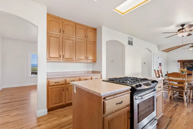 a kitchen with granite countertop a sink stove and cabinets