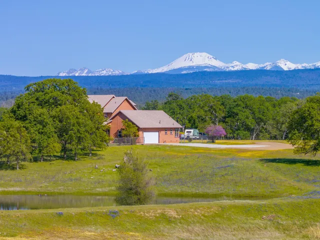 a view of a house with pool and a yard