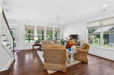 a kitchen with stainless steel appliances kitchen island granite countertop a table chairs and a sink