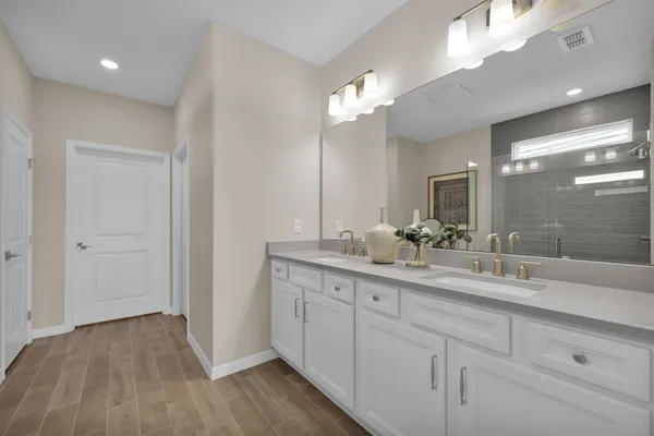a spacious bathroom with a double vanity sink and a mirror