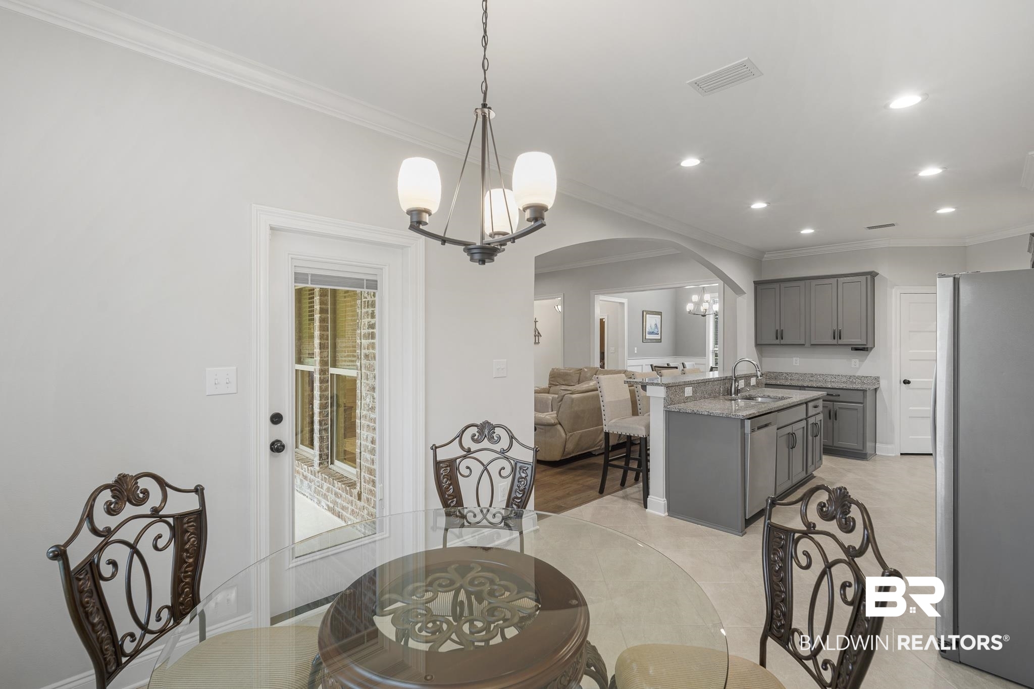 12672 Squirrel Drive Daphne, AL 36527 - Photo 16 of 49 Open-concept dining area featuring a contemporary chandelier and crown molding