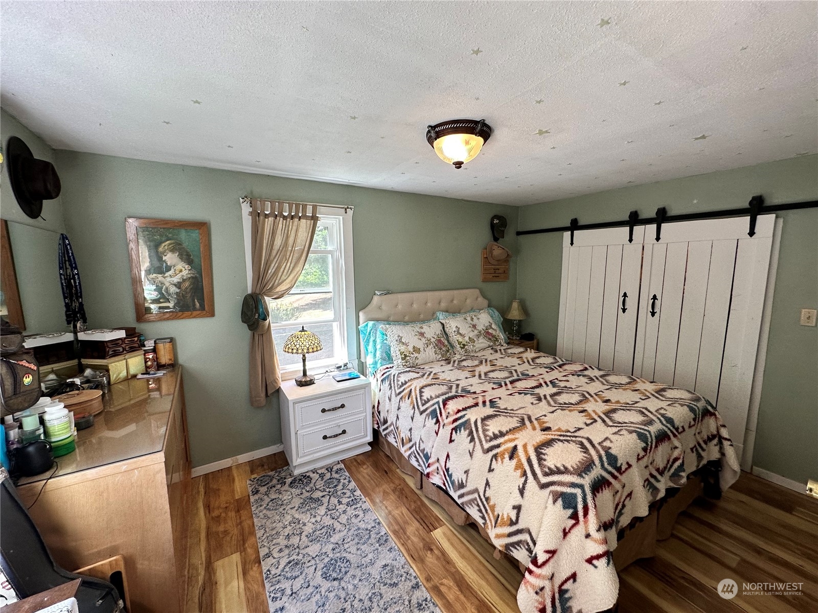 732 Gasman Road Port Angeles, WA 98362 - Photo 13 of 35 a bedroom with a bed flat screen tv and windows