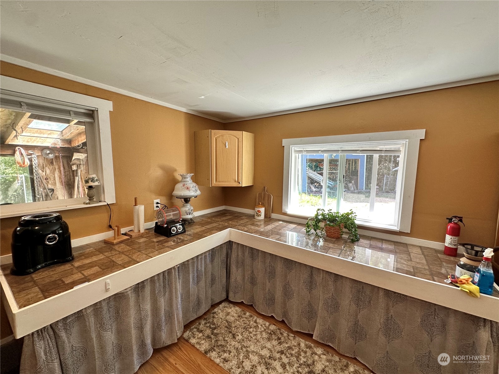 732 Gasman Road Port Angeles, WA 98362 - Photo 23 of 35 a kitchen with a sink stove and cabinets