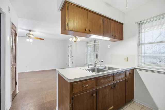 a kitchen with a sink and cabinets