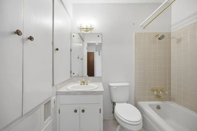 an empty room with a ceiling fan and a window