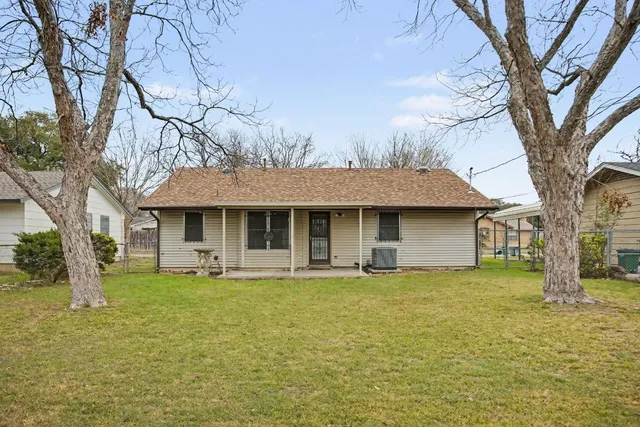 a front view of a house with large garden