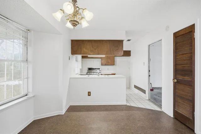 a view of kitchen with sink refrigerator and window