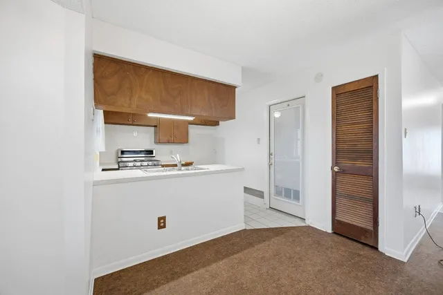 a view of kitchen cabinets and wooden floor