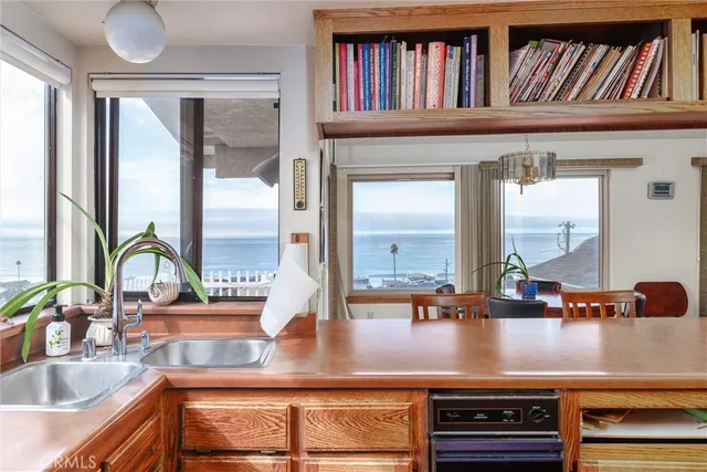 a view of living room with a large window and book shelf