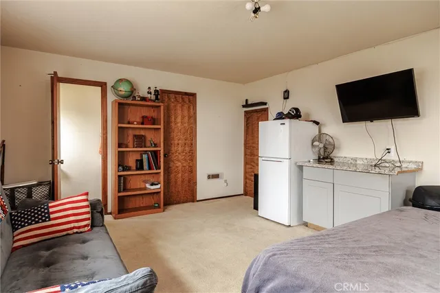 a bedroom with a bed and flat screen tv